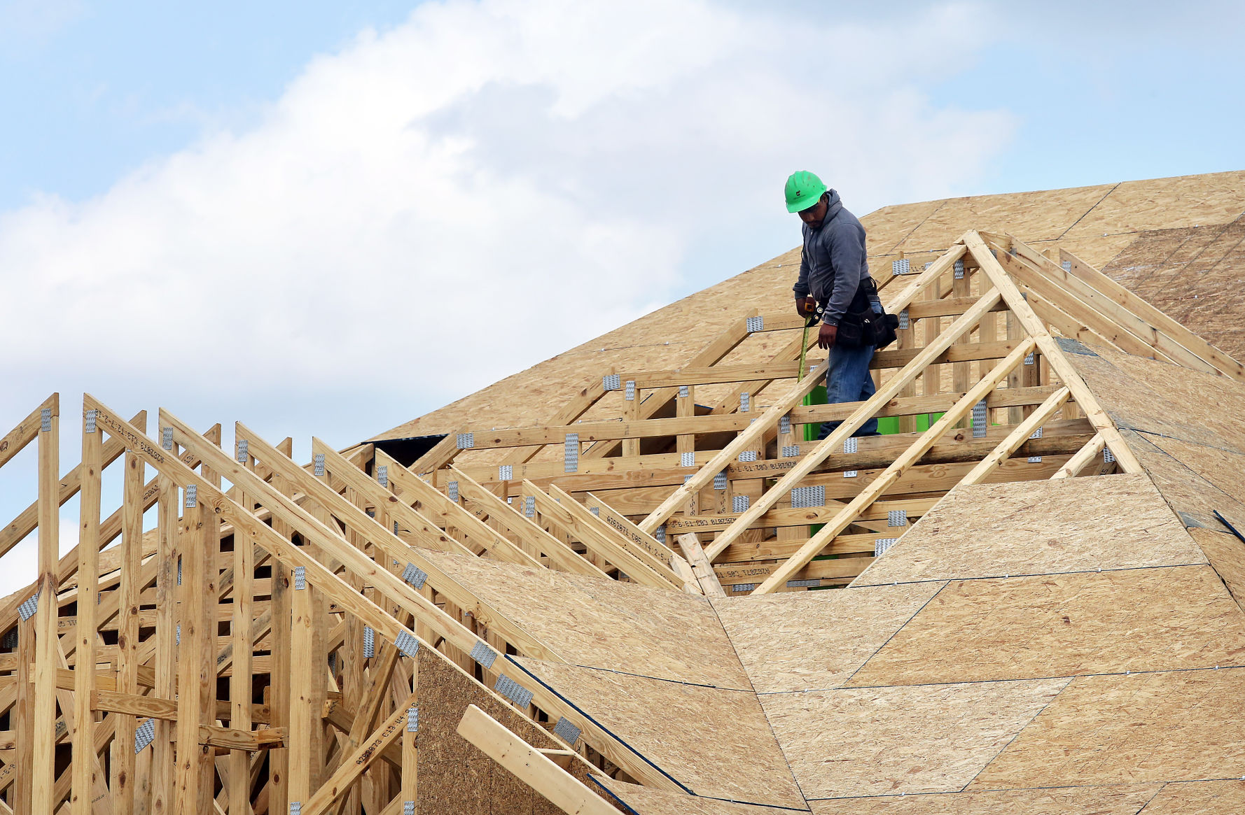 Carnes Crossroads worker on roof of house under construction (copy)